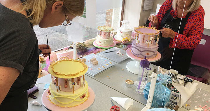 Bex and Jackie working on carousel cake 2021