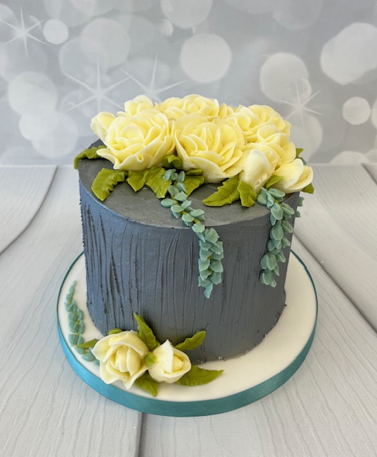 February Saturday " Buttercream Sponge covering and piped Roses.